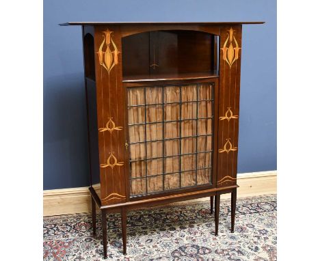 An Art Nouveau inlaid mahogany cabinet in the manner of Shapland &amp; Petter, with shelf above a leaded glazed door flanked 