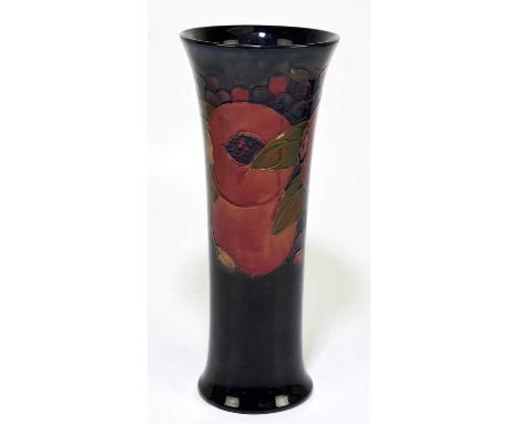 MOORCROFT; a 'Pomegranate' pattern vase, decorated in shades of red, blue, green and ochre against a blue ground, impressed m