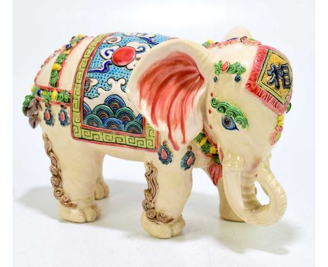 A Chinese ceramic model of an elephant, two impressed seal marks to the underside, length 22cm.