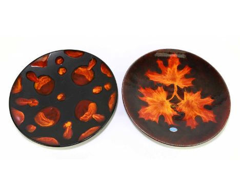 POOLE POTTERY; two contemporary wall chargers, including an example with orange lava effect decoration on a matte black groun