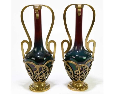 A pair of Austrian Art Nouveau ceramic glazed vases inside gilt metal mounts with scrolling decoration, height 29cm (2).Condi