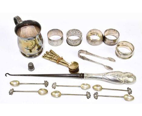 A mixed collection of hallmarked silver items to include napkin rings, a silver handled button hook, a christening mug and wh