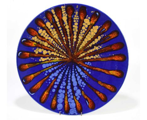 ALAN CLARKE; a limited edition ceramic wall charger decorated with a sunburst type design with gilt highlights, signed and nu