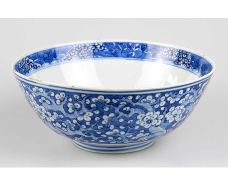 A 19th century Chinese blue and white porcelain footed bowl, painted with prunus flowers to the outside and with prunus flowe