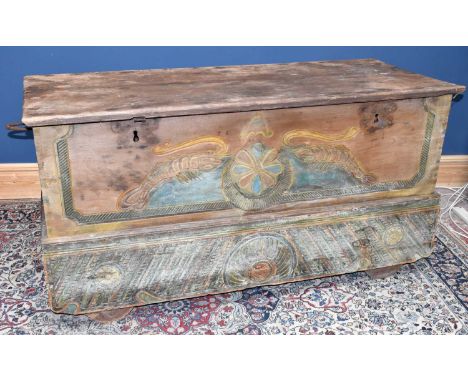 A large 19th century Continental carved hardwood trunk, the front with carved and painted detailing, with board plinth base, 