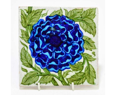 WILLIAM DE MORGAN TILE; a glazed earthenware tile decorated with a blue flower, oval mark verso, 13cm x 13cm.Provenance: The 