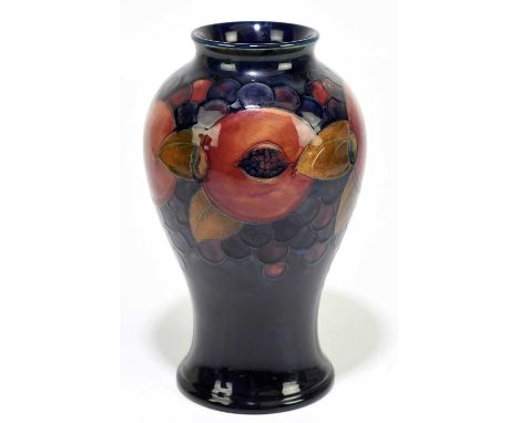 MOORCROFT; a 'Pomegranate' pattern vase, decorated with fruit and berries against a blue ground, impressed marks and painted 