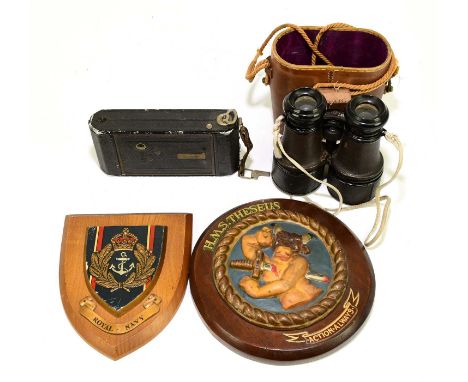 A pair of binoculars together with a Zeiss Icon filming camera, a Royal Navy shield and H.M.S Theseus plaque (4).