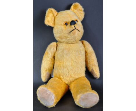 A charming vintage English soft toy teddy bear, likely Chiltern or Chad Valley. The bear firmly stuffed with short golden moh