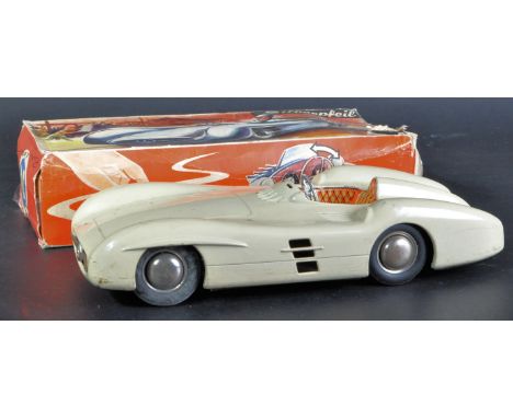 An original vintage West Germany made tinplate friction motor model car. The Mercedes / Silver Arrow racing car with cream bo