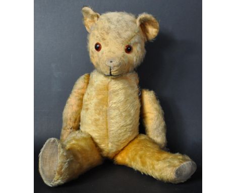 An original vintage English (likely Chad Valley) soft toy teddy bear. Short golden mohair with jointed limbs, beaded eyes and