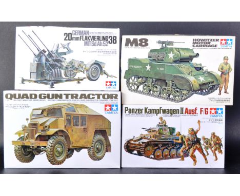 A collection of x4 vintage Tamiya 1/35 scale Military themed plastic model kits to include; Quad Gun Tractor, M8 Howitzer Mot
