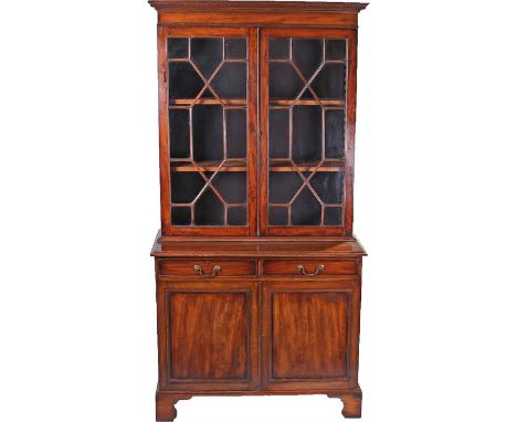 Mahogany bookcase cabinet, in the George III taste, the concave cornice above an astragal glazed pair of doors enclosing shel