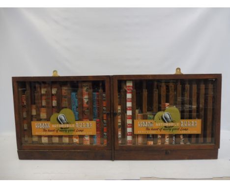 A Lumax Automobile Bulbs two door wall hanging cabinet containing an assortment of bulbs in original packaging, 39 3/4" w x 1