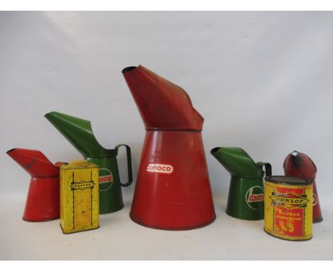A collection of assorted oil measures and tins including Castrol and Dunlop. 