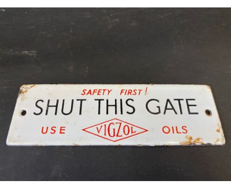 A small Vigzol Oils 'Shut This Gate' enamel sign, 7 1/2 x 2 1/2".