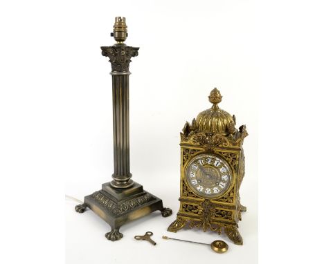 Gilt metal mantel clock with twin train movement, the dial with white enamelled numeral cartouches, with pierced and scrollin