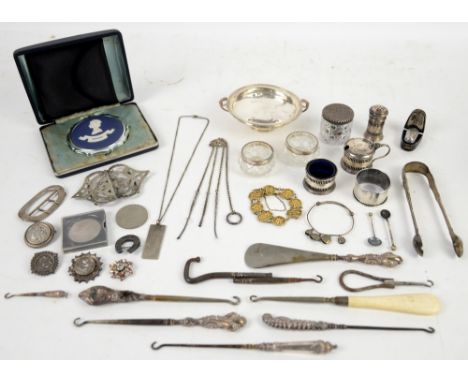 Selection of silver and white metal items to include a small pedestal pin dish, silver-plated belt-buckle, sugar nips, napkin