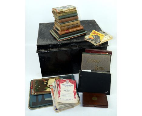 A metal trunk containing various scrap books, drawing books, newspaper cutouts and children's learning material and literatur