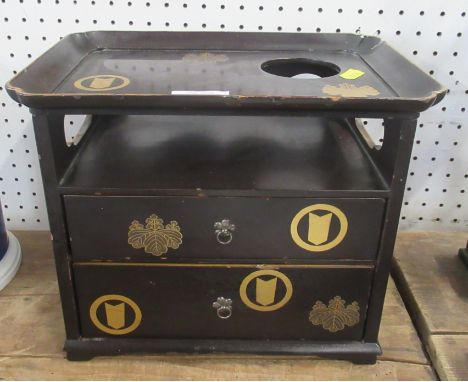 An Eastern black lacquered table cabinet, fitted with a tray top over a shelf and two drawers, with gilt decoration, 11ins x 