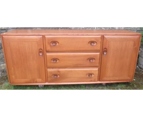 An Ercol design sideboard, width 61ins, depth 18ins, height 27ins&nbsp;