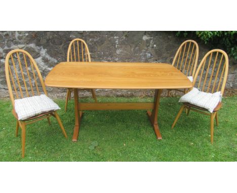 An Ercol dining table and four chairs, 58ins x 32ins, height 29ins, with fire labels&nbsp;
