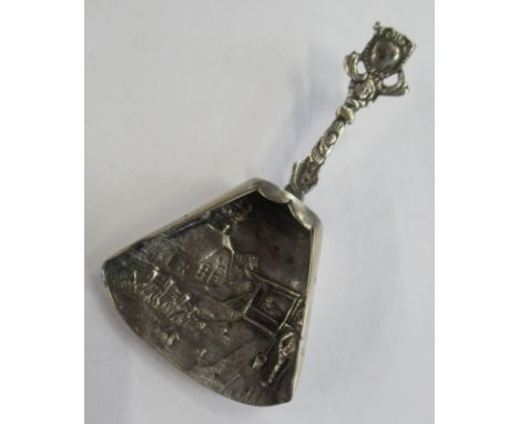 A Continental silver caddy spoon, with embossed decoration