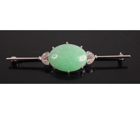 A white metal, jade and diamond knife-edge bar brooch, the cabochon celadon jade measuring 19 x 18.1 x 6.4mm, flanked to eith