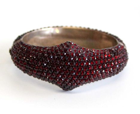 A late Victorian rose cut garnet pavé set hinged and domed cluster bangle, the whole set with small rose cut garnets to a wid
