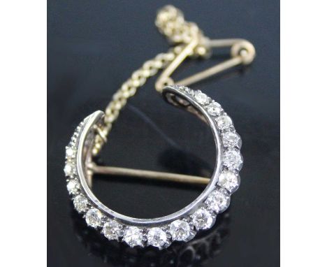 A late Victorian yellow and white metal, diamond crescent brooch, featuring 17 graduated Old European cut diamonds in cut-dow