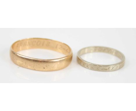 A yellow metal wedding band, inscribed to the inside, unmarked but tests as approx 14ct gold, 4.1g, size S; together with a F