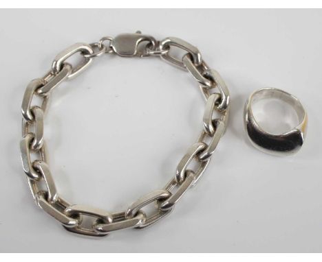 A modern silver chain link bracelet 19cm, together with a modern silver dress ring, size K, gross weight 46.9g (2)