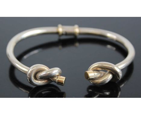 A Gucci silver and 18ct gold tipped bangle, having knotted ends and twist action, 34g, 7cm, boxed