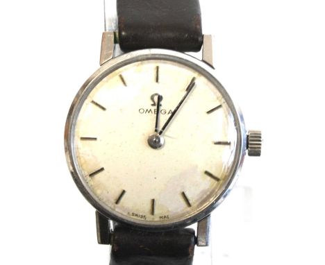 A lady's Omega stainless steel manual wind wristwatch with round white baton dial, fitted to an Omega black leather strap wit