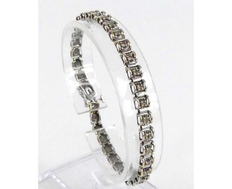 A 9ct white gold diamond tennis style bracelet, having box clasp and figure-of-eight safety catch, 36 single cut diamonds all