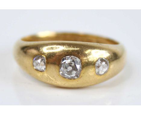 A gent's 18ct gold diamond three-stone ring, the flush set graduated old cushion cuts total weight estimated as 0.54 carats, 