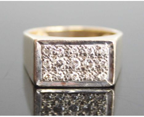 A 9ct yellow and white gold diamond rectangular signet ring with 15 round brilliant cut diamonds in grain settings. Diamond d