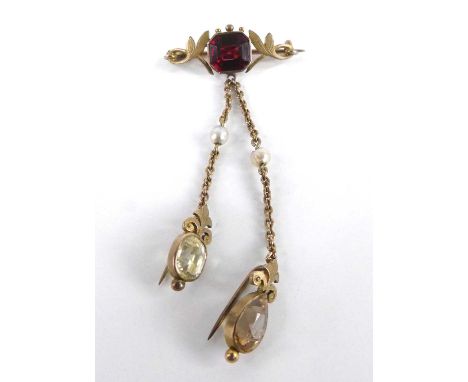 An Edwardian yellow metal multi-stone bar brooch, featuring an octagonal garnet within a foliate surround with two oval trace