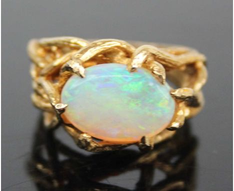 An 18ct gold and cabochon opal set dress ring, the claw set opal measuring approx 12.2 x 8.7 x 3.6mm, all in a setting and ba