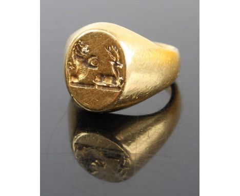 A Kutchinsky 18ct gold signet ring, the head with relief carved armorial, 13.9g, size I, London 1976Ring is heavily scratched