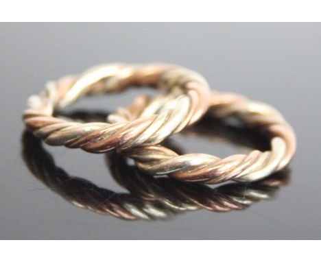 A pair of 9ct rose white and yellow rope twist rings. Widths 3.1mm, finger size K approx. Gross weight 8.1g, partial hallmark