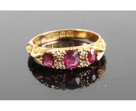An Edwardian ruby &amp; diamond half hoop ring, arranged as three graduated oval cut rubies, the largest measuring approx 4.9