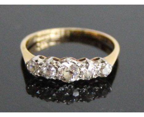 A yellow and white metal diamond half eternity ring, comprising five graduated Old European cut diamonds in claw settings, di