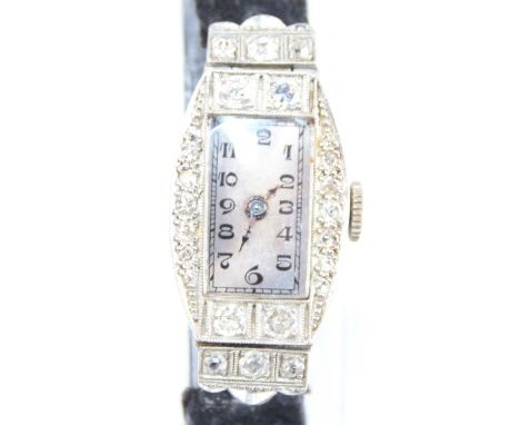 An Art Deco lady's platinum and diamond set cocktail watch, having an Arabic tank dial within a case being pavé set with grad