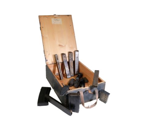 A GERMAN MILITARY AMMUNITION BOX with a quantity of various gun magazines and gun butt endsÂ&nbsp;