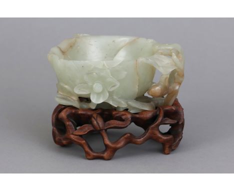 Chinesische Jadeschale auf Holzstandhellgrüne Jade mit dunklen Einschlüssen, geschnitzt, vertiefte Blütenform mit plastischem