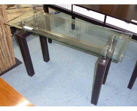 CONSOLE TABLE, with bevelled glass top, on square leather clad supports, 122cm x 44cm x 76cm H. 