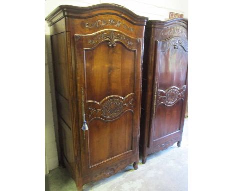 BONNETIERE, French Louis XV manner cherrywood with an arched cornice, foliate carved decoration and a single panelled door en