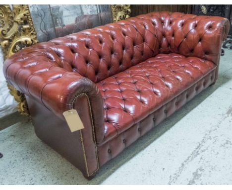 CHESTERFIELD SOFA, 20th century deep buttoned red leather upholstery raised on bun supports, 188cm x 82cm x 70cm H. (slight f