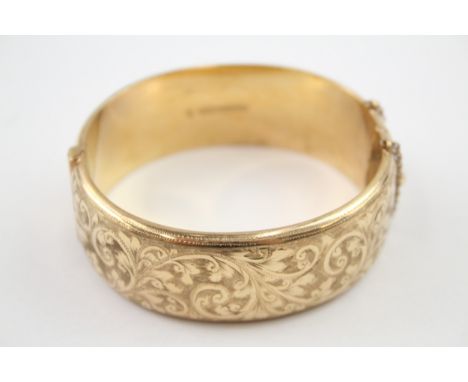 Rolled gold bangle with scrolling foliate design (42g) 